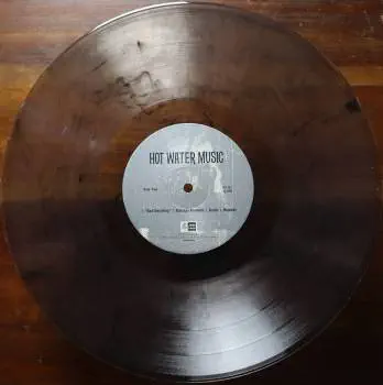 <u>PRESSING INFO</u><br><table class=inf_press><tbody><tr class=inf_info><td class=inf_title>Album:</td><td class=inf_info> Hot Water Music Split on Ultra Clear with Black Ice (Jade Tree Exclusive)  </td></tr>
    <td class=inf_title>Pressing:</td><td> Seventh Pressing /500  </td></tr>
    <td class=inf_title>Release Date:</td><td> July 29th 2022  </td></tr>
    <td class=inf_title>Album Pressed:</td><td> 2022  </td></tr>
    <td class=inf_title>Label:</td><td> Jade Tree Records JT1067 82119-1  </td></tr>
    <td class=inf_title>Insert:</td><td> Printed Glossy Inner Sleeve  </td></tr>
    <td class=inf_title>Barcode:</td><td> 0 45778-21191 3  </td></tr>
    <td class=inf_title>Side A Matrix:</td><td> EPTÂ·82119Â·1Â·A SAFF  </td></tr>
    <td class=inf_title>Side B Matrix:</td><td> EPTÂ·82119Â·1Â·B SAFF  </td></tr>
    <td class=inf_title>&nbsp;</td><td> <a href=https://www.discogs.com/release/24047822 target=_blank rel=noopener noreferrer>View This Release on Discogs</a>  </tr></tbody></table>
<br><u>PRICING</u><span class='less' style='padding-left: 8px; color: var(--font-colour_grey);'>(prices shown in USD)</span><br><table class='inf_press'><tbody><tr class='inf_info'>
            <td class='inf_title'>Last Sold:</td>
            <td>$30.00 (Mar 27, 2026)</td>
            </tr><tr class='inf_info'>
            <td class='inf_title'>History:</td>
            <td>
                <span class='price-low' title='Sold on Oct 9, 2023'>Low: <span class='price-value'>$29.99</span></span>
                <span class='price-separator'>|</span>
                <span class='price-avg'>Avg: <span class='price-value'>$38.66</span></span>
                <span class='price-separator'>|</span>
                <span class='price-high' title='Sold on Aug 13, 2022'>High: <span class='price-value'>$55.00</span></span>
            </td>
            </tr></tbody></table><br>    <br><br><u>TRACKLIST</u><br><table class='inf_tracks'><tbody><tr>
            <td class='inf_num'>A1</td>
            <td class='inf_trk'>Alkaline Trio - Queen Of Pain</td>
            <td class='inf_len'>3:57</td>
            <td><a href='#' class='lyric-link' data-album-code='splits' data-song-title='Alkaline Trio - Queen Of Pain'>Lyrics</a></td></tr><tr>
            <td class='inf_num'>A2</td>
            <td class='inf_trk'>Alkaline Trio - While You’re Waiting</td>
            <td class='inf_len'>4:07</td>
            <td><a href='#' class='lyric-link' data-album-code='splits' data-song-title='Alkaline Trio - While You’re Waiting'>Lyrics</a></td></tr><tr>
            <td class='inf_num'>A3</td>
            <td class='inf_trk'>Alkaline Trio - Rooftops</td>
            <td class='inf_len'>2:15</td>
            <td><a href='#' class='lyric-link' data-album-code='splits' data-song-title='Alkaline Trio - Rooftops'>Lyrics</a></td></tr><tr>
            <td class='inf_num'>B1</td>
            <td class='inf_trk'>Hot Water Music - God Deciding</td>
            <td class='inf_len'>2:37</td>
            <td><a href='#' class='lyric-link' data-album-code='splits' data-song-title='Hot Water Music - God Deciding'>Lyrics</a></td></tr><tr>
            <td class='inf_num'>B2</td>
            <td class='inf_trk'>Hot Water Music - Russian Roulette</td>
            <td class='inf_len'>3:25</td>
            <td><a href='#' class='lyric-link' data-album-code='splits' data-song-title='Hot Water Music - Russian Roulette'>Lyrics</a></td></tr><tr>
            <td class='inf_num'>B3</td>
            <td class='inf_trk'>Hot Water Music - Radio</td>
            <td class='inf_len'>4:12</td>
            <td><a href='#' class='lyric-link' data-album-code='splits' data-song-title='Hot Water Music - Radio'>Lyrics</a></td></tr><tr>
            <td class='inf_num'>B4</td>
            <td class='inf_trk'>Hot Water Music - Bleeder</td>
            <td class='inf_len'>3:13</td>
            <td><a href='#' class='lyric-link' data-album-code='splits' data-song-title='Hot Water Music - Bleeder'>Lyrics</a></td></tr></tbody></table><br><br>
    <u>NOTES</u><br> Printed inner sleeve (Heavier cardstock and slightly glossier finish compared to 1st presses)
 - B